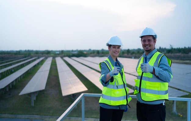 Careers team electrical engineers inspecting solar panels hundred acres grass rooftop energy storage station evening after completing daily work tasks with setting sun 921283 1769