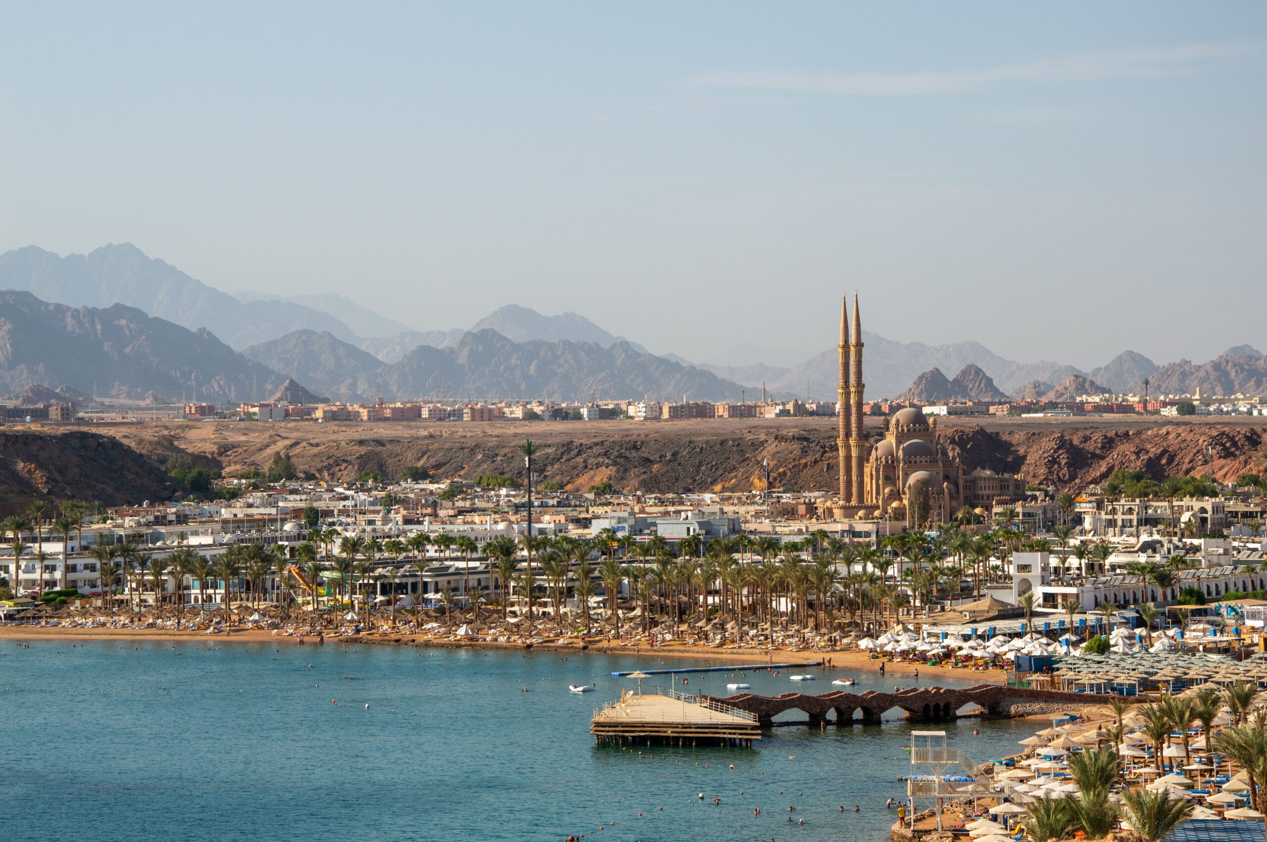 EIA and Wildlife Hazard Management Plan for Radamis Tourist Complex, Sharm El-Sheikh A stunning aerial view of Sharm El Sheikh featuring the coastline and city landmarks against a mountainous backdrop.