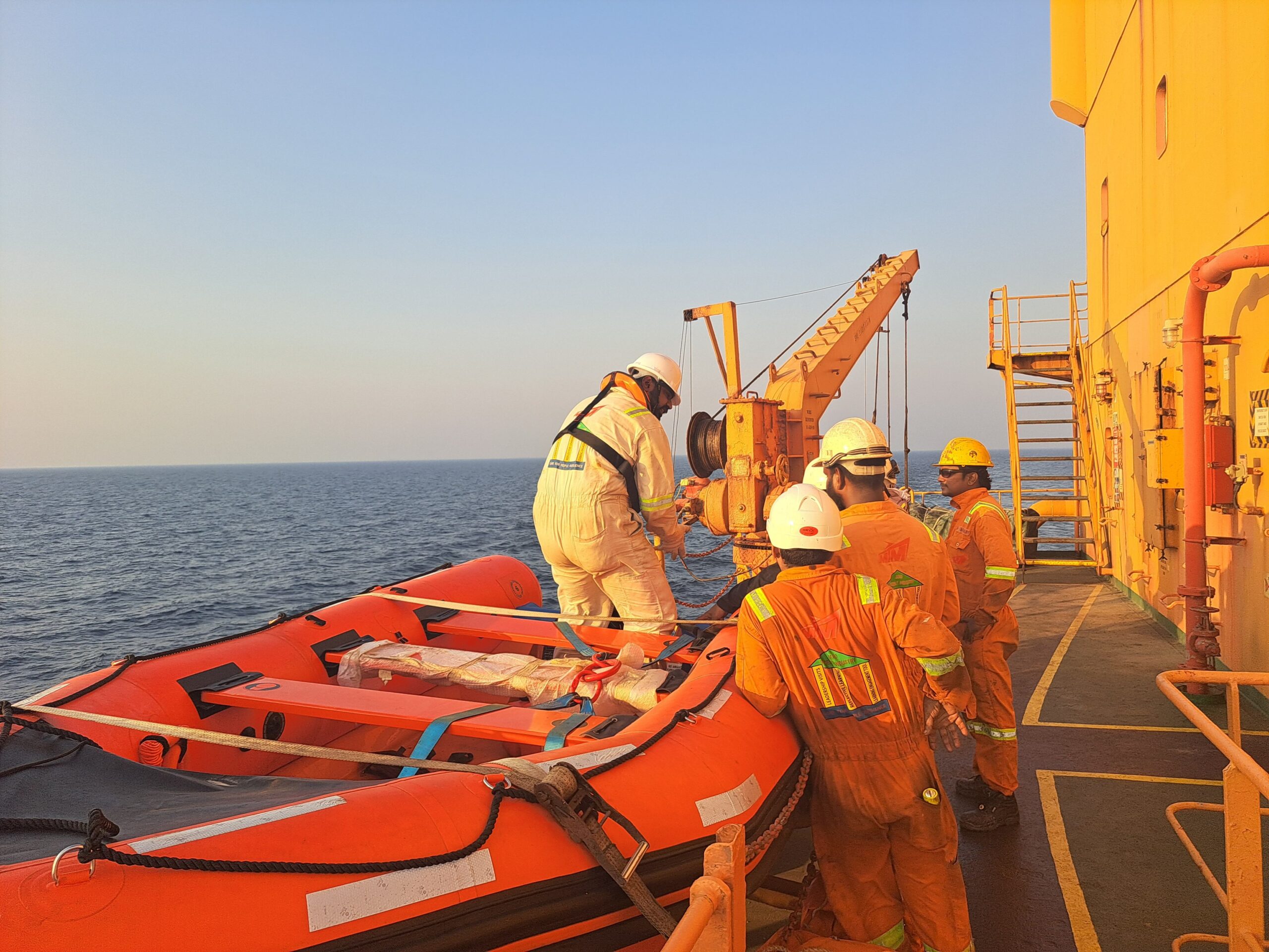 Ecological Marine Survey, Hydrodynamic and Shoreline Morphological Modelling for the 18-inch LPG J-10D / RSH Pipeline, Ras Shukheir Crew members in protective gear ready a lifeboat during an offshore safety drill on a ship.